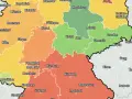 Deutschlandkarte mit farbigen Regionen, die den mietpreis pro qm anzeigen. Orange, gelb und grün markieren unterschiedliche Preisniveaus.