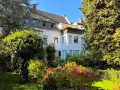 Ein schönes Haus in Reisholz, umgeben von üppigem Grün. Die Immobilienpreise hier spiegeln die idyllische Lage wider.