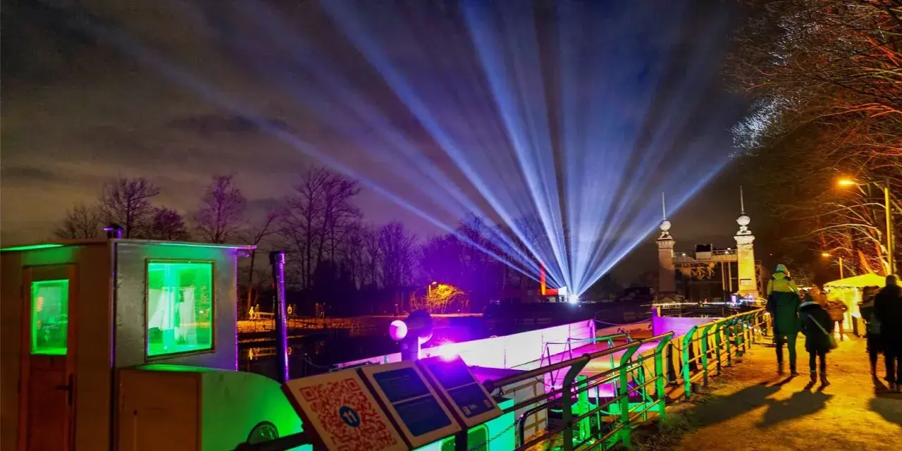 Lichterzauber am weihnachtsmarkt schiffshebewerk henrichenburg. Strahlende Lichtkegel erhellen den Nachthimmel über dem beleuchteten Schiffshebewerk.