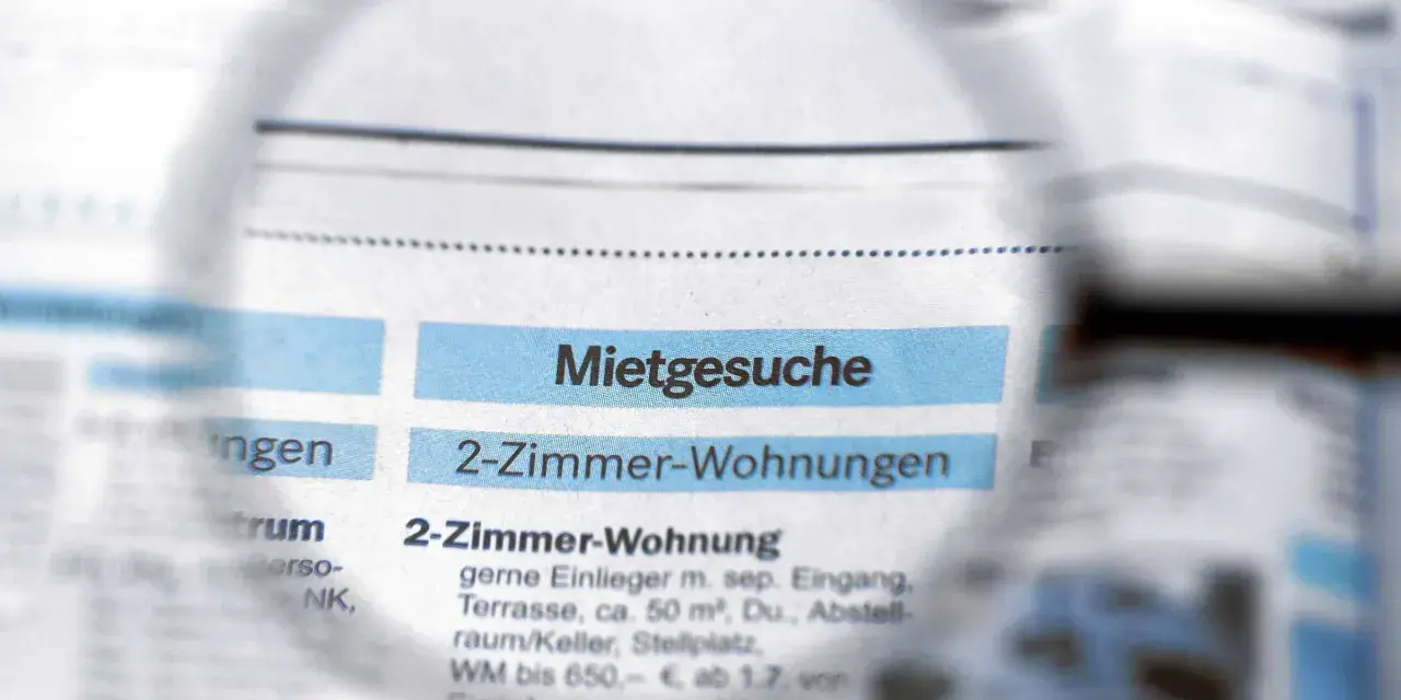Lupe über Zeitungsanzeigen mit "Mietgesuche" und "2-Zimmer-Wohnungen". Ein Blick auf den Mietspiegel Moers.