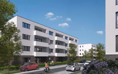 Moderne Wohnanlage im Kronprinzenviertel Dortmund mit Balkonen, Autos und grünen Bäumen.