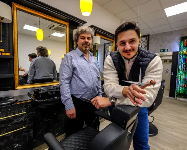 Zwei Herren in einem modernen Salon, bereit für einen Haarschnitt. Der Salon "Schnittkaue Recklinghausen" bietet stilvolle Atmosphäre und professionelle Pflege.