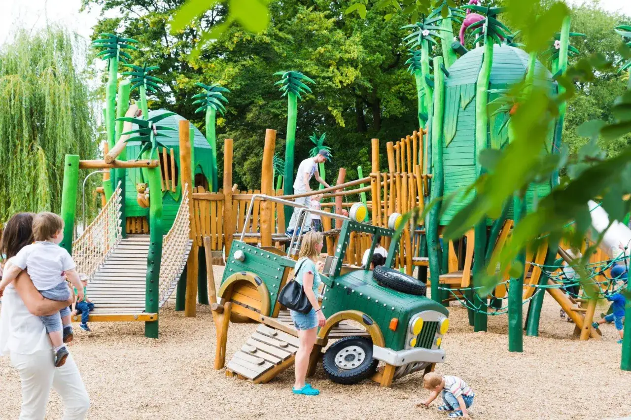 Abenteuer-Spielplatz mit Dschungel-Thema. Hier gibt es viel zu entdecken, was mit Kleinkindern Unternehmen Spaß macht: eine grüne Jeep-Kletterstruktur, Hängebrücken und Türme.