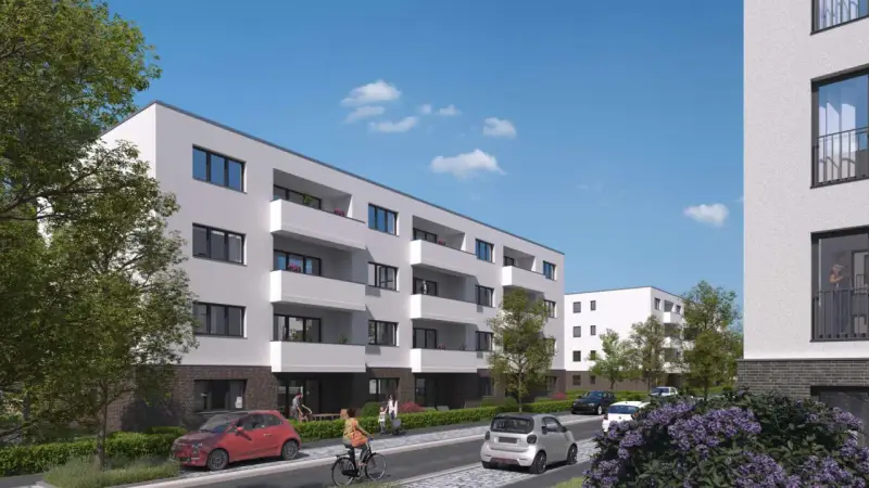 Moderne Wohnanlage im Kronprinzenviertel Dortmund mit Balkonen, Autos und grünen Bäumen.